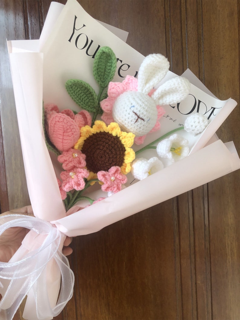 Handgehaakt bloemboeket met konijnenknuffel en garenbloemen in zachtroze papier