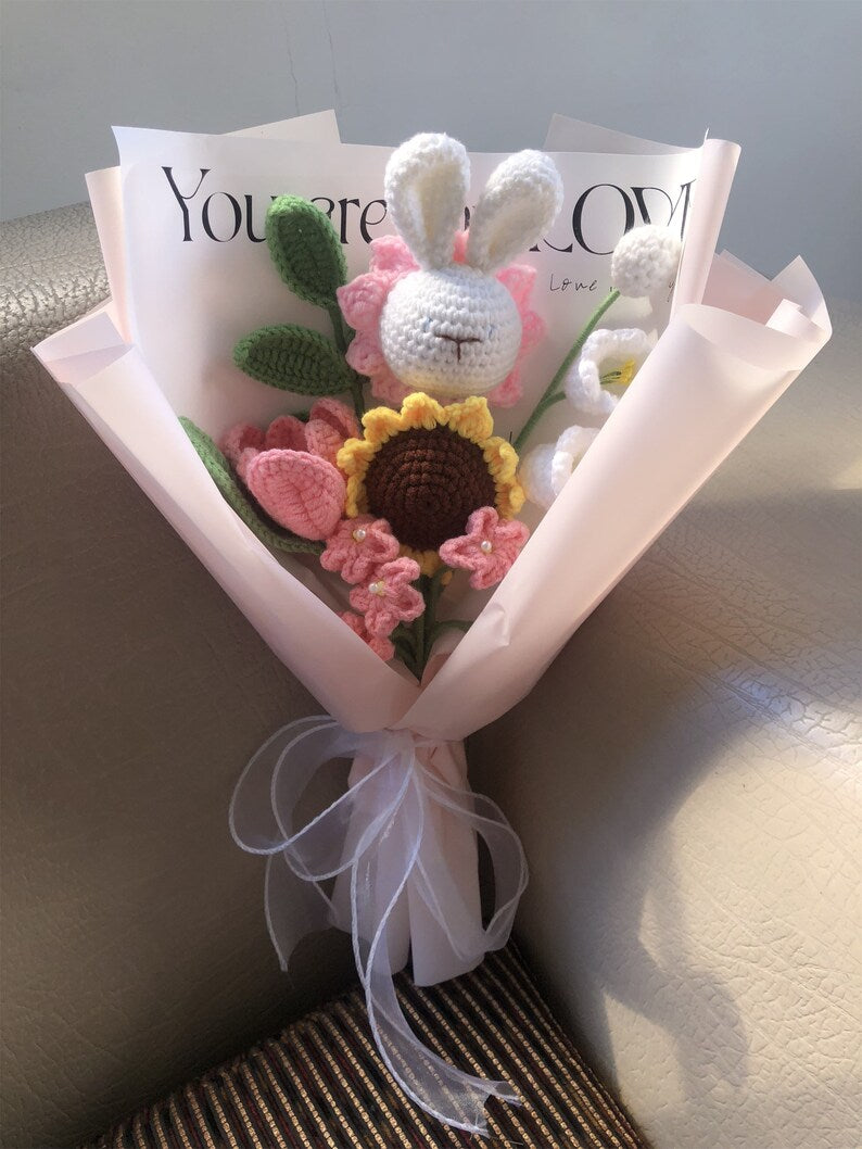 Handgehaakt bloemboeket met konijnenknuffel en garenbloemen in zachtroze papier