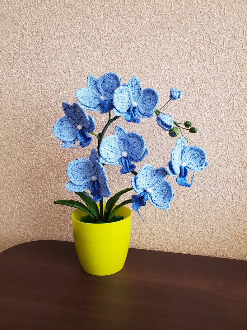 Gehaakte orchideeplant in gele pot, blauw bloemdecor van acrylgaren