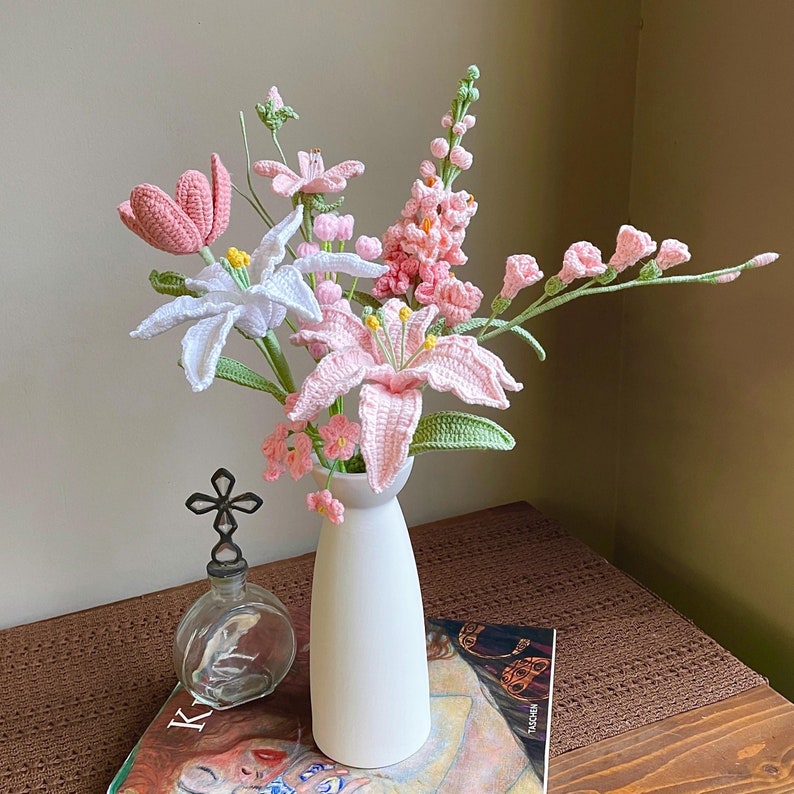 Gehaakt bloemboeket met blauwe lelies, tulpen en rozen in vaas