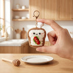 Gehaakte voedselsleutelhanger met schattig gezicht en gestructureerde uitstraling